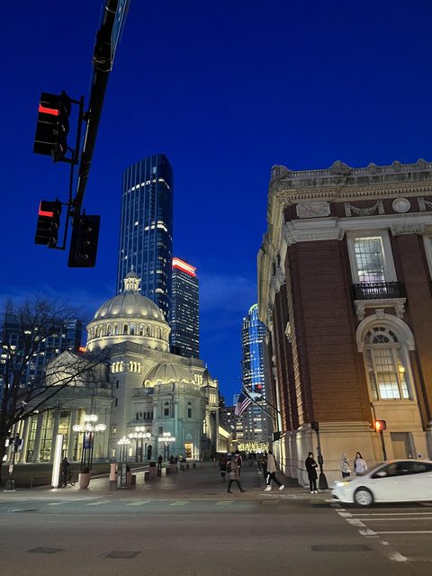 Boston's Christian Science Plaza and Back Bay towers lit up at dusk