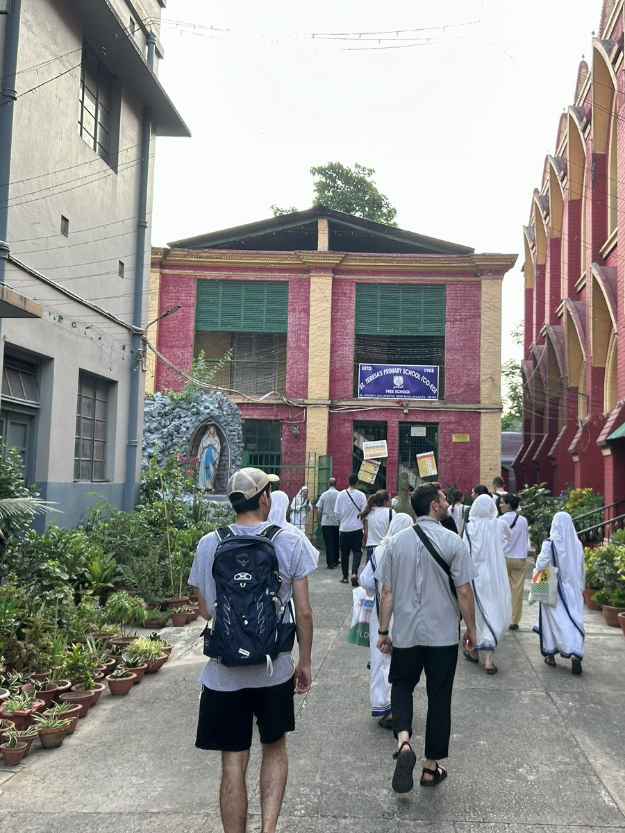 Jordon walking with a group and Missionaries of Charity sisters toward St. Teresa's Primary School in Kolkata